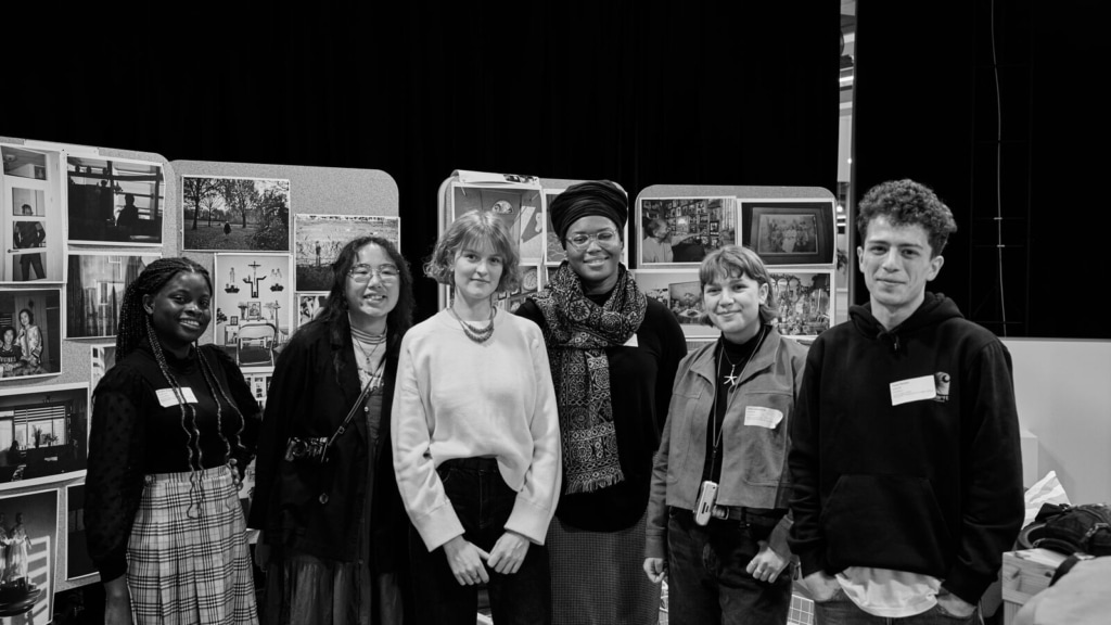 The six mentees standing in front of their photo exhibition.