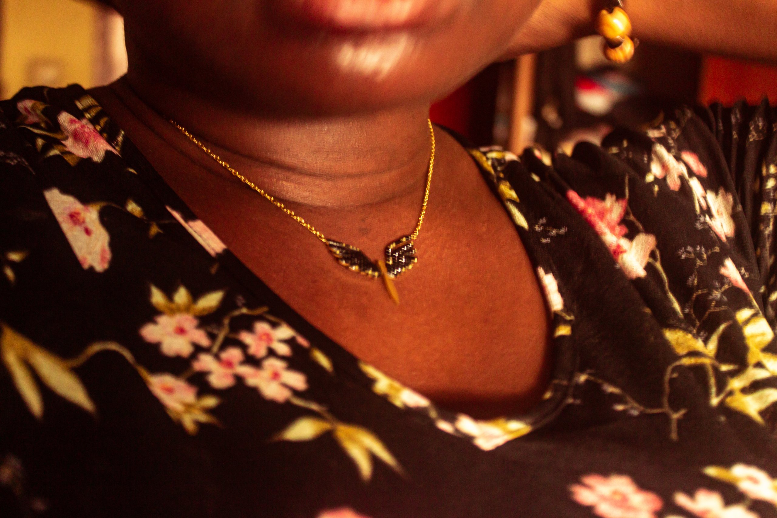Closeup of Ife's gold necklace.
