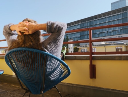 Lady relaxing on her balcony, with her feet up