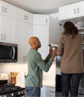 Couple arranging things in their Kitchen