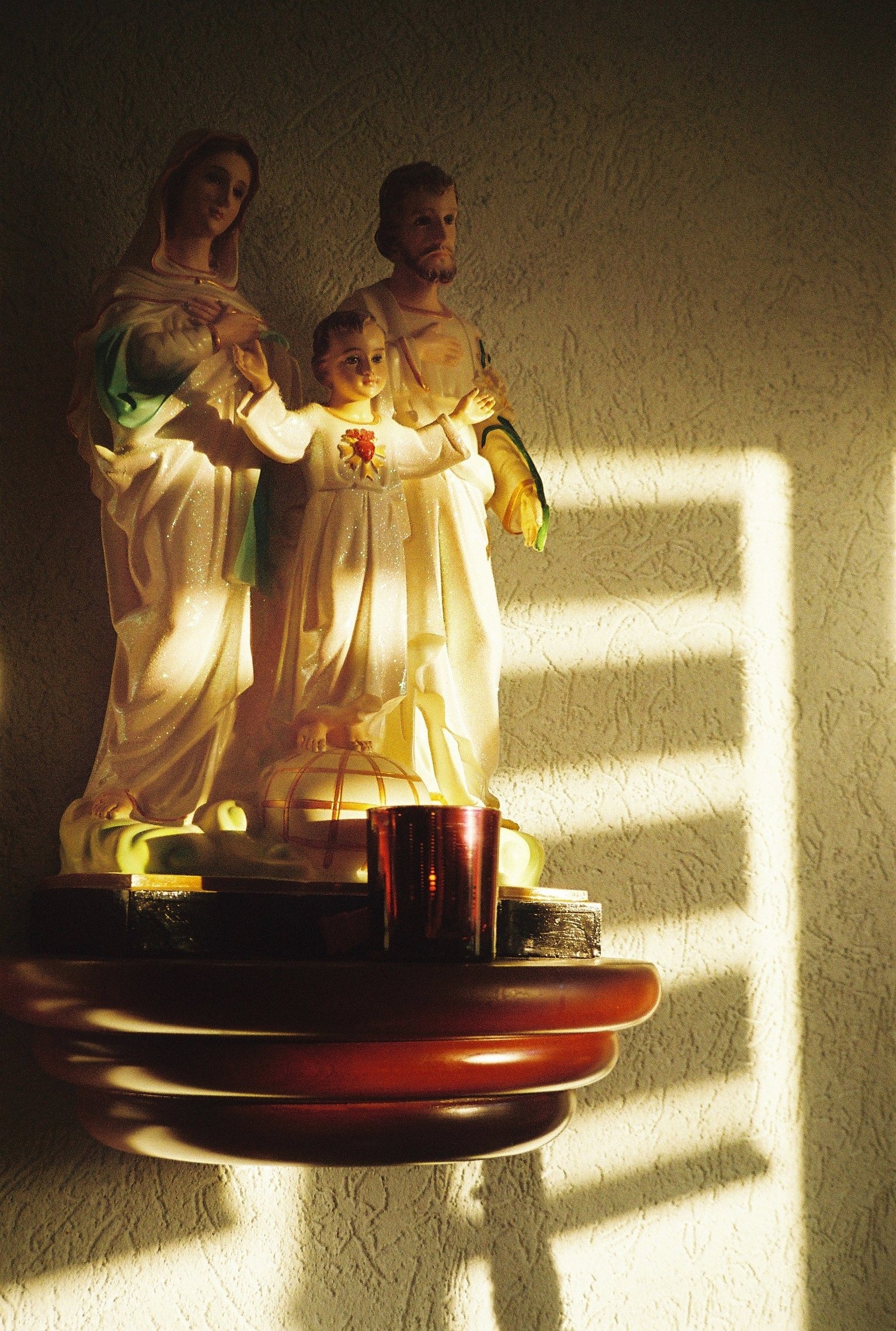 Closeup of a statue of the holy Mary, Joseph and Jesus as a child.