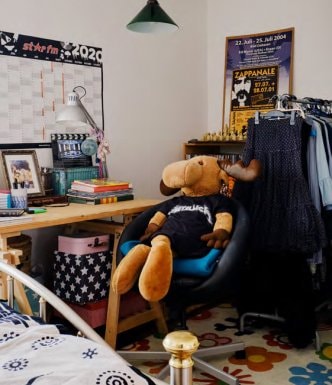 Large moose toy, sitting at a desk wearing a Metallica shirt